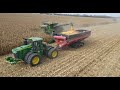 Two john deere x9 1100 combines with 16 row corn heads harvesting a 640 acre field in illinois