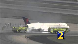 RAW: Delta plane catches fire after landing