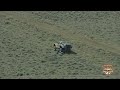 Bryce Menzies changing a flat as Robby Gordon goes by at the 2026 Vegas to Reno Off-Road Race