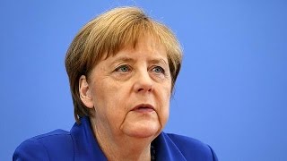 Angela Merkel stands by refugee policy after attacks in Germany