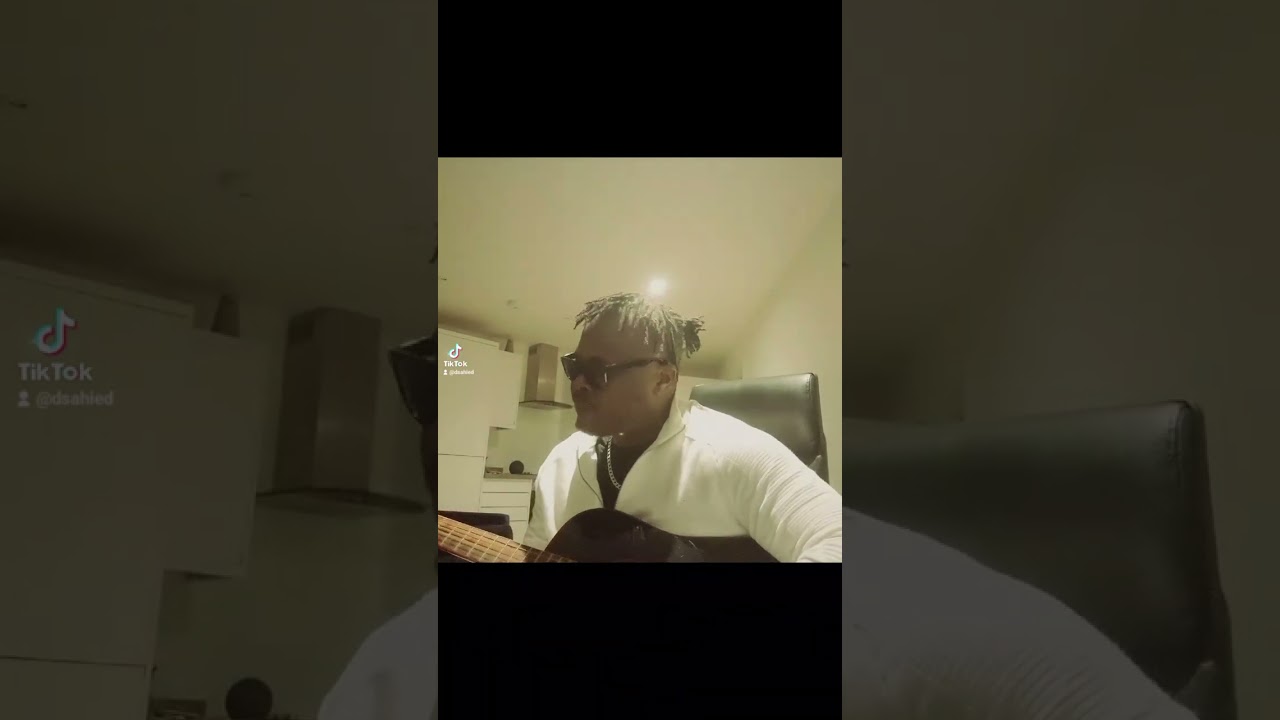 Dsahied playing guitar live in uk