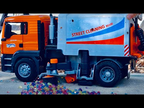 playing with Brüder toys is fun - STREET SWEEPER and Cat Tractor in action