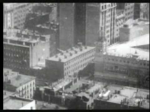 Photographed April 11, 1905. American Mutoscope and Biograph Company Location: Broadway and 7th Avenue, between 42nd and 43rd Streets Camera: Wallace McCutcheon The view is from the top of 1 Times Square Originally named Longacre Square, it was renamed Times Square on April 8, 1904, by proclamation of Mayor George B. McClellan, Jr. at the urging of Adolph Ochs, owner and publisher of the New York Times. It is also known as 1475 Broadway, New York Times Building and New York Times Tower. The north end later became Duffy Square. The building is a 25 story, 365 foot (110.6 m) high skyscraper at 42nd and Broadway in Times Square. It was the second tallest building in the world when it opened. The camera pans to the north over the tops of the buildings from Bryant Park, south of 42nd Street (behind the New York Public Library) [0:39] up 6th Avenue to the Hippodrome Theatre, between 43rd & 44th Streets [1:04]. A marquee on the theater reads 'A Yankee Circus On Mars.' The camera continues to rotate toward 44th and 45th Streets between 6th and 7th Avenues, until coming to rest looking directly north up Times Square to 46th Street, where Broadway (left) and 7th Avenue (right) diverge again. The Hippodrome Theatre [1:04] also opened in 1905 and was, at the time, New York's largest indoor stage. It was built and owned by Frederick Thompson, the man responsible for creating Luna Park in Coney Island. The Hippodrome closed in 1939. Recommended reading: AIA Guide to New York City <b>...</b>