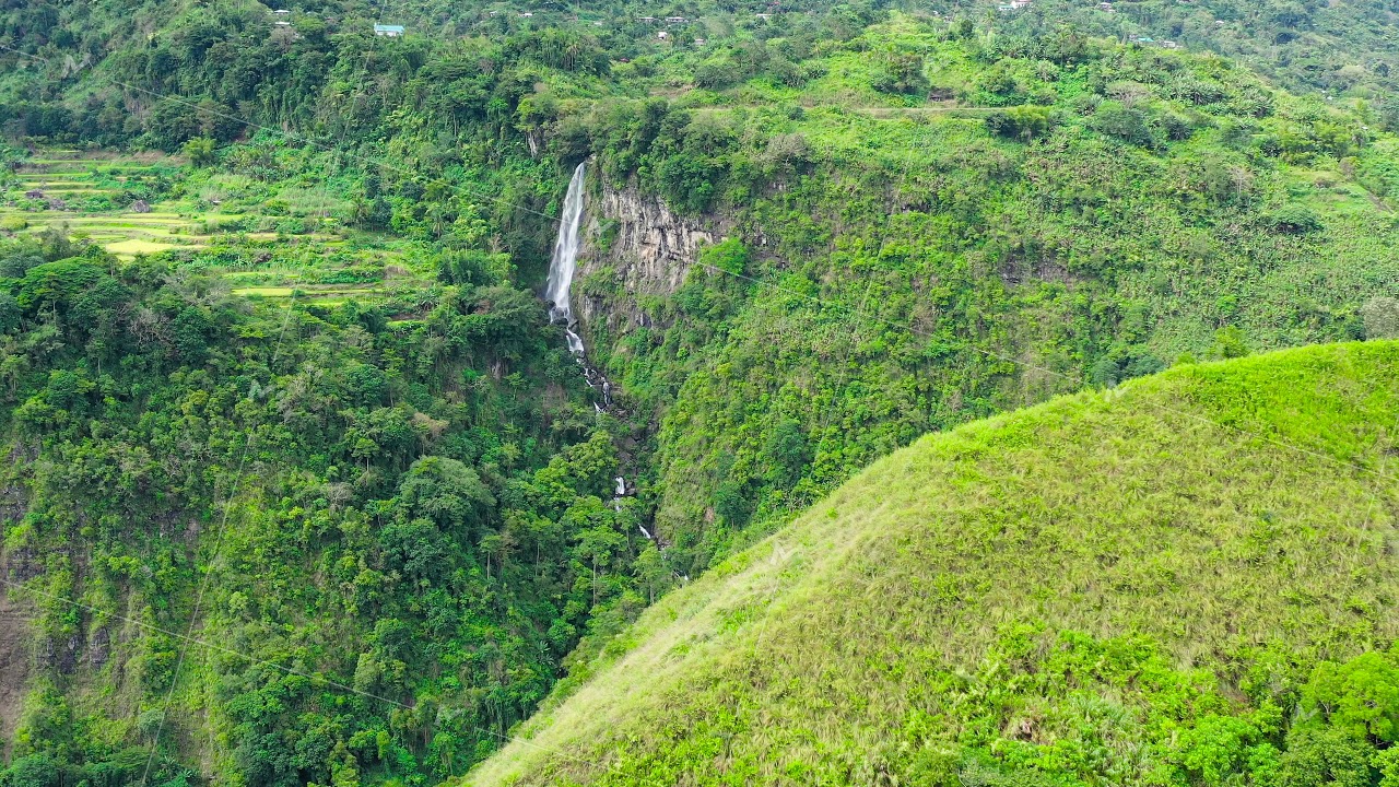 Cordillera on Luzon Island, Philippines, aerial view. Evergreen forest and waterfall on the side of
