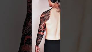A fierce dragon with fiery red-orange accents against deep black tones, freehand by Trung Tadashi.
