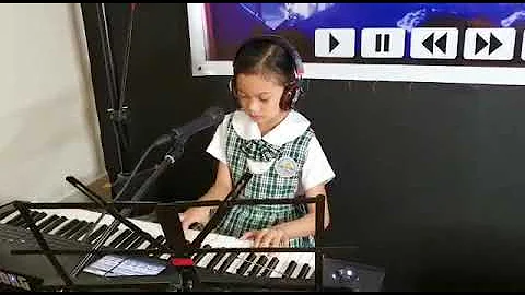 Gracey Salazar playing piano while singing ANAK