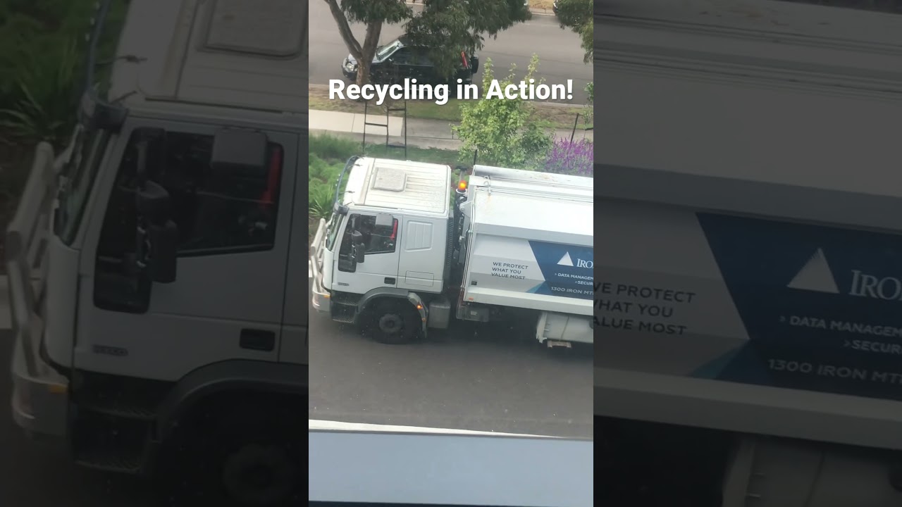 Iron mountain recycling truck  picking up bins full of paper in Melbourne Australia.