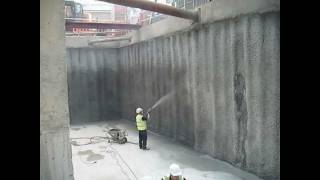 Spray application of Vandex Unimortar 1 tanking slurry to piled basement retaining wall