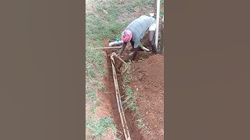 Slow motion video - Indian former working in a form to fix the broken water pipe