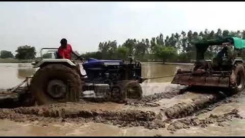 #tractor stuck in deep mud #pulling out by #powertrack