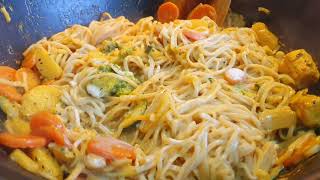 Simple and delicious noodles with vegetables and coconut milk served with chicken skewers?