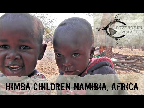 Excited children see themselves on a video camera in a remote Himba village in Namibia, Africa.