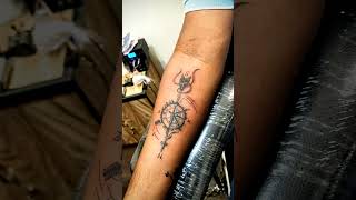 compass tattoo designs on arm , arrow wit compass tattoo with red n baby blue colour highlights
