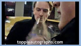 Michael Fassbender blows smoke out his nose, signs autographs for TopPix