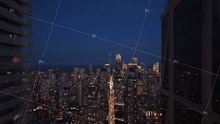 Aerial pull back shot between two skyscrapers in Toronto's illuminated urban canyon, vibrant
