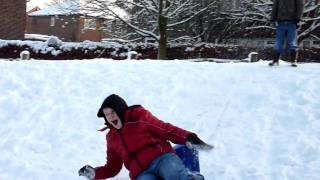 George sledging down a slope