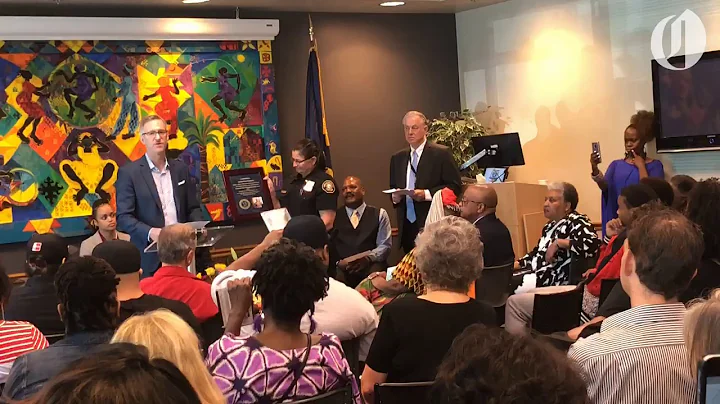 Mayor Ted Wheeler presents plaque to Antoinette Ed...