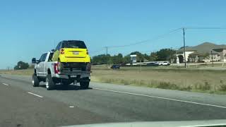 SmartCar in the bed on a monster F250