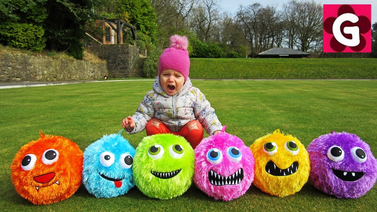 Gaby playing with colorful balls in a park