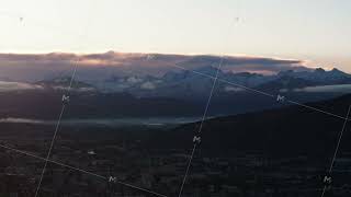 Panoramic view of high alpine peaks covered with snow against clouds in sunrise sky. Mont Blanc