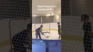 Indoor Basement Hockey Rink Featuring Synthetic Ice, Boards, Nets, and a Bench Area