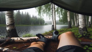 Extreme weather camping in Finland. Fishing trip gone wrong. Setting a tarp shelter against a storm.