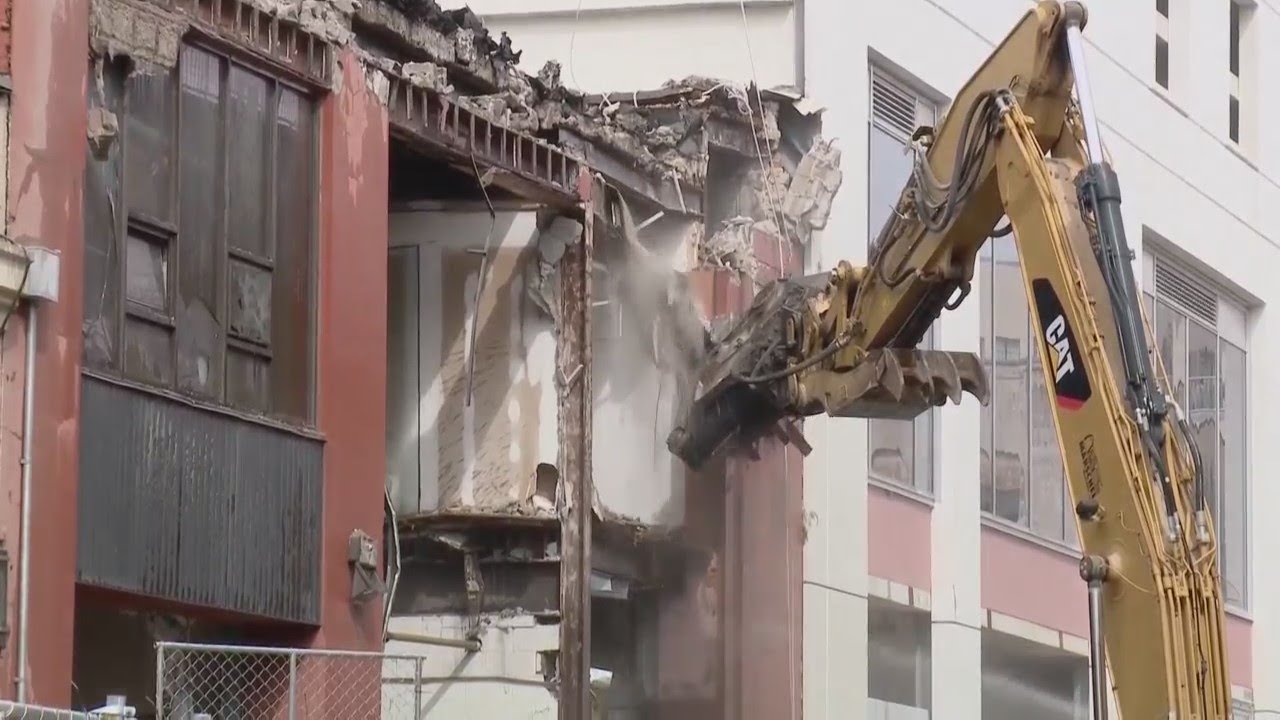Demolition begins on buildings next to collapsed hotel - YouTube
