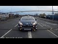 Grown man riding a mini moto on the roads undertaking and running red light