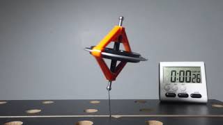 Toy Gyroscope on Needle at about 41 Degree Tilt Rises in 0:35. Falls in 1:00. Loud Cranking Noise