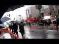 Robert Downey Jr decides to cross the street in the pouring rain to greet his fans!