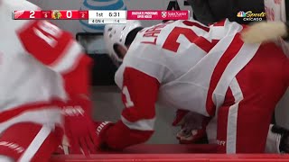 Dylan Larkin heads to the locker room after a push from Connor Murphy