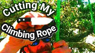 Cutting my climbing rope while I'm hanging from it .