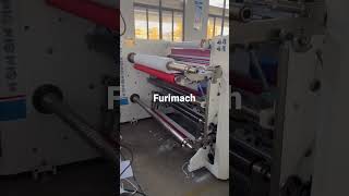 Film slitting machine with spool winder for edge trimming