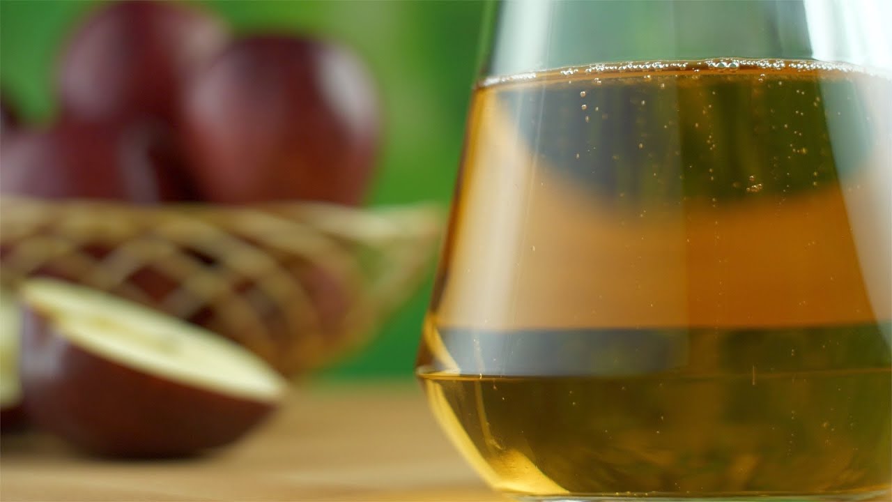 Closeup shot of fresh apple juice in a glass jug or a containe... | Indian Stock Footage | Knot9