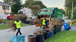 WM Garbage Truck Packing A Masive Yard Waste Pile