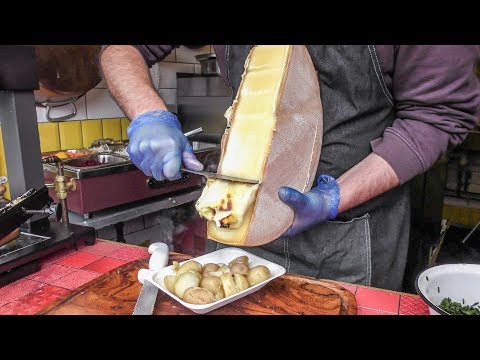 Yummy Swiss Raclette. Warm Melted Swiss Cheese with Egg and Potatoes. London Street Food