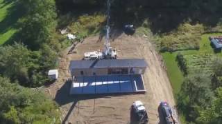 Didn't know you could do that!? Watch a mobile home crane lifted onto a basement foundation.