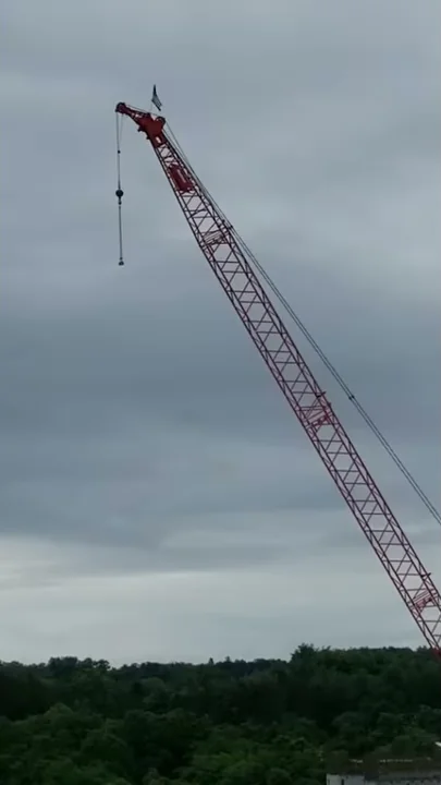 Construction workers honoring our country's flag