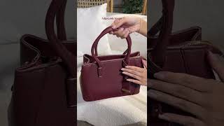 Carry your style boldly in deep, versatile burgundy bag. Content