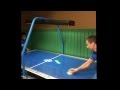 Dadbodgames play air hockey against a little boy