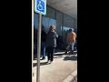 Unemployment benefit claimants line up to verify ID