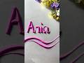 Writing the name Aria in sand