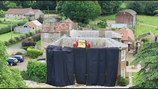 Environmental activists cover UK PM Sunak's home in black fabric | AFP