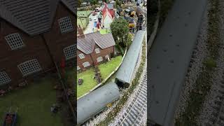 Past the village Class 24/1 97201 Experiment pulling a Ransomes crane and maintenance coaches.