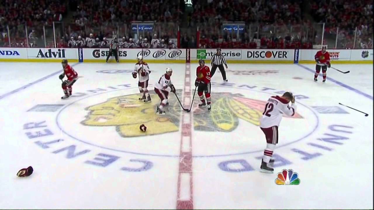 Chicago Blackhawks left wing Brandon Bollig (52) and Phoenix Coyotes left  wing Paul Bissonnette (12) fight during the first period of game 4 of the  NHL Western Conference quarterfinals at the United