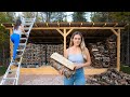 Building a firewood shed in the woods at off grid cabin
