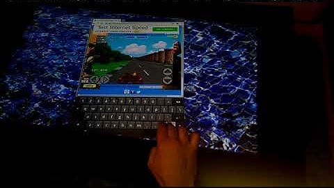 Playing outrun driving game on Jigabyte touch screen coffee table