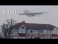 Airbus a380 emerge from thick fog above the houses