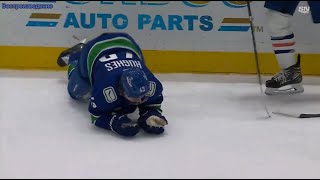 Quinn Hughes was upset and forced to leave the ice after McDavid cut him open with a high stick.