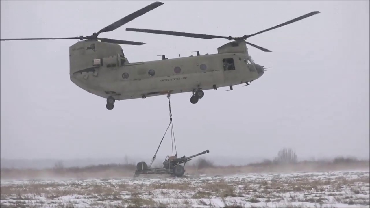 Attaching a M119A3 Howitzer to a CH-47 Chinook Helicopter
